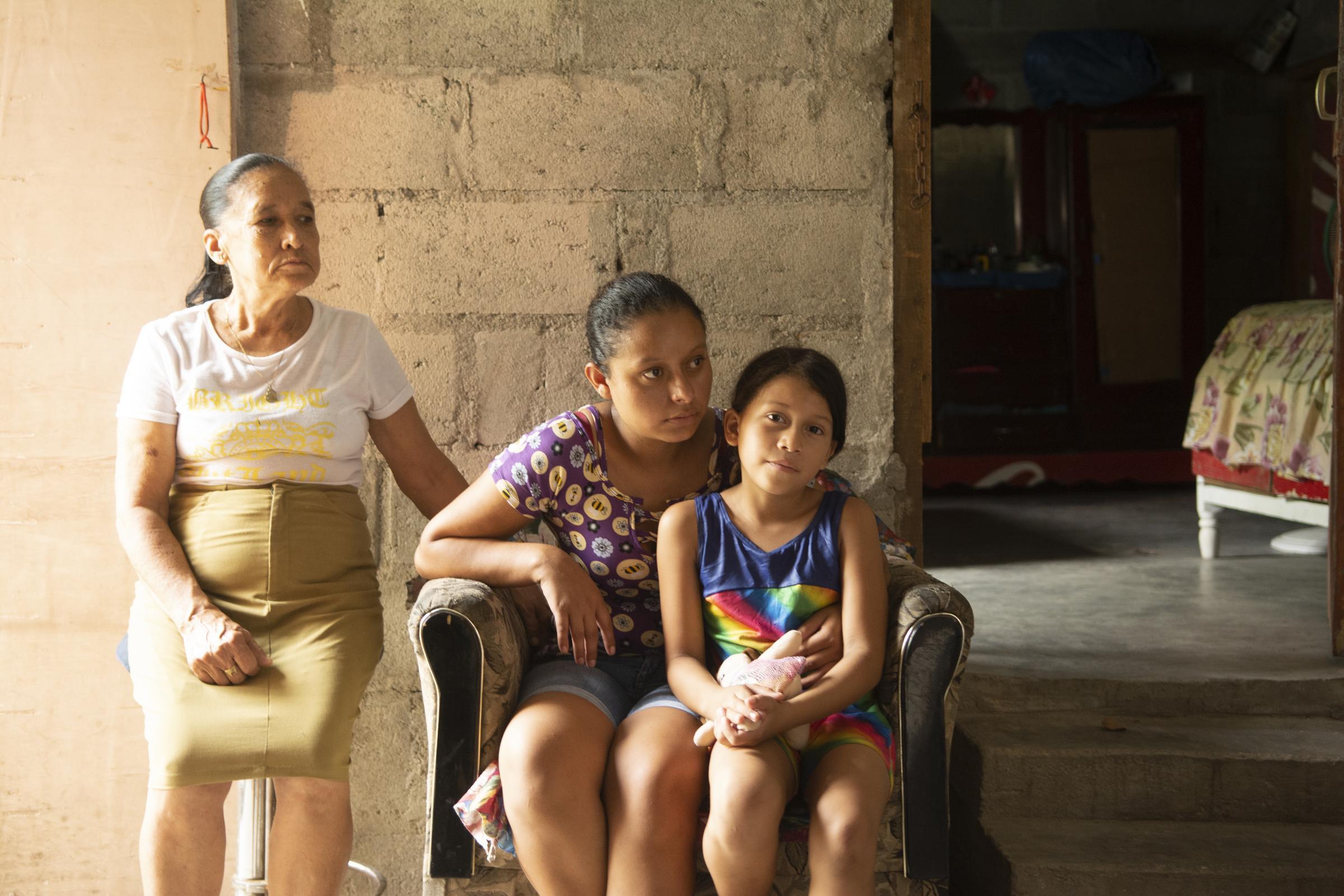 Eine Mutter sitzt mit ihrer Tochter gemeinsam auf einem Sessel in Bordos, Honduras. Die Grossmutter steht daneben (Quelle: Christian Nusch/Victor Zavaleta Carbajal) Eine Mutter sitzt mit ihrer Tochter gemeinsam auf einem Sessel in Bordos, Honduras. Die Grossmutter steht daneben (Quelle: Christian Nusch/Victor Zavaleta Carbajal)